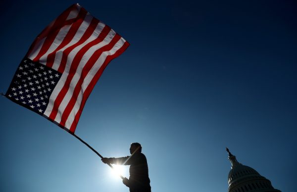 A supporter of U.S. President Donald Trump holds a flag as he participates in a 