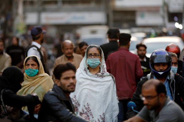 Women wear protective masks as they walk through a crowd along a market, as the outbreak of the coronavirus disease (COVID-19) continues, in Karachi, Pakistan 2 December, 2020 (Photo: Reuters/Akhtar Soomro/File Photo).