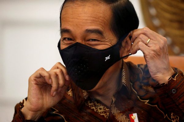 Indonesian President Joko Widodo reacts as he wears a protective mask during an interview with Reuters at the Presidential Palace in Jakarta, Indonesia, 13 November 2020 (Photo: Reuters/Willy Kurniawan).