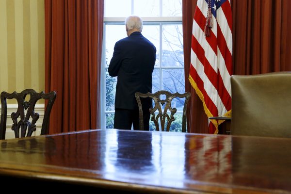 Joe Biden stands at a window looking out to the South Lawn at the Oval Office, White House, Washington DC, 14 April 2015 (Photo: Reuters/Jonathan Ernst).