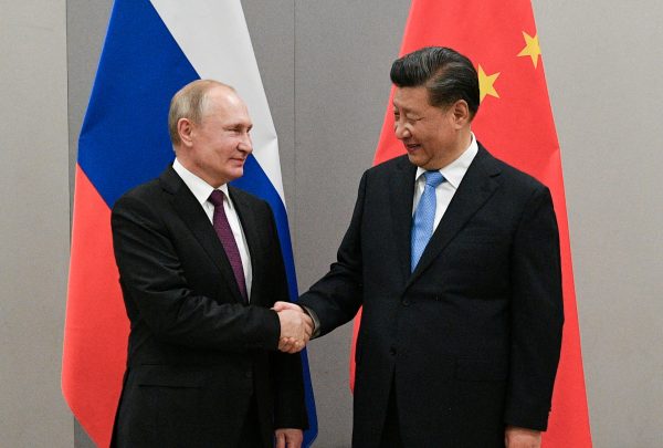 Russian President Vladimir Putin shakes hands with Chinese President Xi Jinping during their meeting on the sidelines of a BRICS summit, in Brasilia, Brazil, 13 November 2019 (Photo: Reuters).