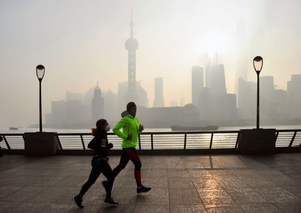 Local residents exercise on the promenade on the Bund against skyline in heavy smog in Pudong, Shanghai, China, 23 February 2019 (Photo: Reuters).