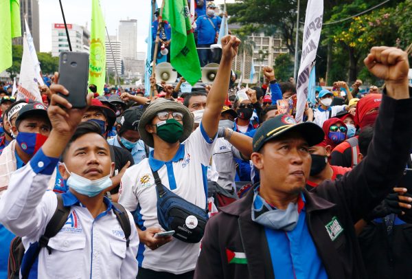 Members of Indonesian trade unions protest against the government's labor reforms in a 'jobs creation