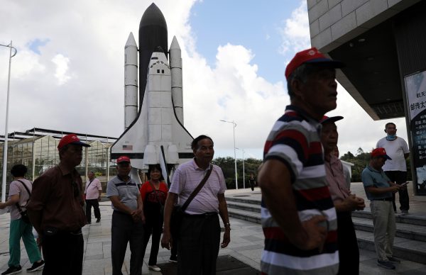 People stand in front of a scaled model of the Challenger space shuttle at a space science museum in Wenchang, Hainan province, China, 22 November 2020 (Photo: Reuters/Tingshu Wang).