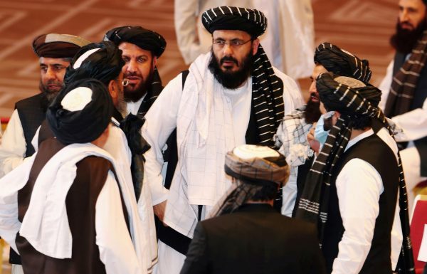 Taliban delegates speak during talks between the Afghan government and Taliban insurgents in Doha, Qatar, 12 September 2020 (Photo: Reuters/Ibraheem al Omari).