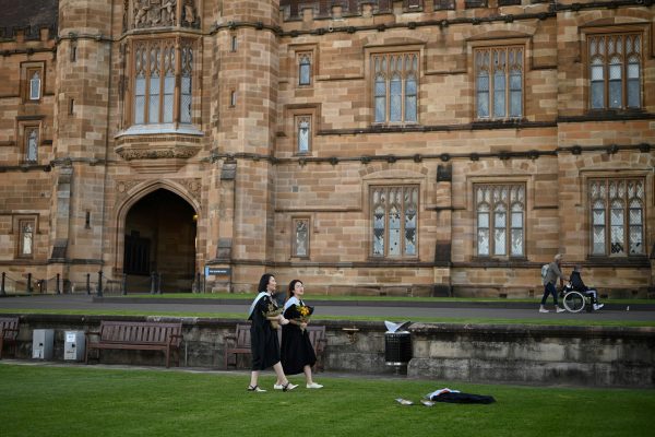International students wear graduation gowns as they take pictures around the University of Sydney's campus, Sydney, Australia, 4 July 2020 (Photo: Reuters/Loren Elliott).