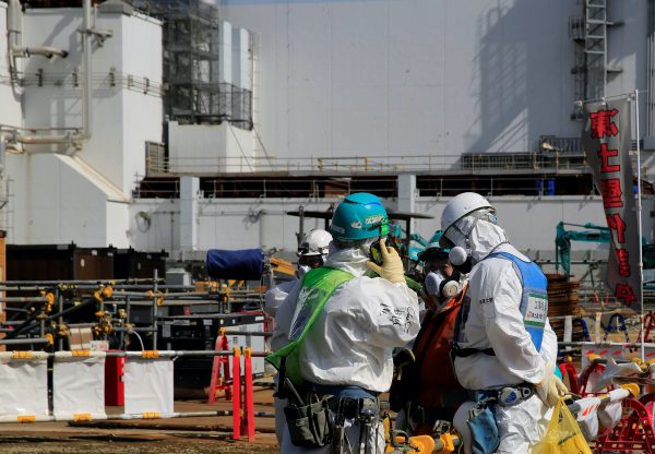 A worker talks on the phone near No. 3 reactor building at the tsunami-crippled Fukushima Daiichi nuclear power plant in Okuma town, Fukushima prefecture, Japan, 1 March, 2021 (Photo: Reuters/Sakura Murakami).