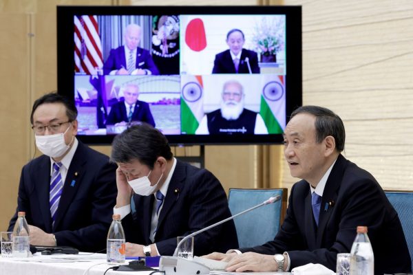 Yoshihide Suga, Japan's Prime Minister, speaks while a monitor displays US President Joe Biden, Australia's Prime Minister Scott Morrison and India's Prime Minister Narendra Modi, during the virtual Quadrilateral Security Dialogue (Quad) meeting at his official residence in Tokyo, Japan, on Friday 12 March 2021 (Photo: Reuters/Kiyoshi Ota/Pool).