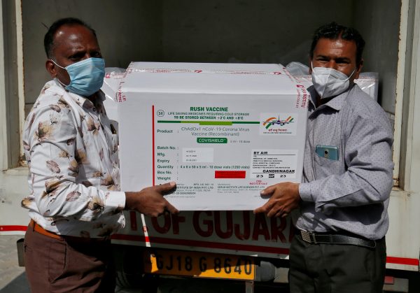 Officials unload boxes containing vials of AstraZeneca's COVISHIELD, a coronavirus disease (COVID-19) vaccine manufactured by Serum Institute of India, outside a vaccination storage centre in Ahmedabad, India, 12 January 2021 (Photo: Reuters/Amit Dave).