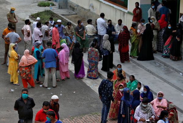 People wait to cast their votes outside a polling station during the eight and final phase of the West Bengal state election in Kolkata, India, 29 April 2021 (Photo: Reuters/Rupak De Chowdhuri).