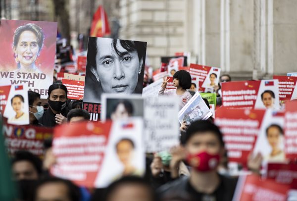 Protesters hold placards during the global Myanmar Spring Revolution as they match to Trafalgar Square in London, 2 May 2021 (Photo: May James/ SOPA Images/Sipa USA).