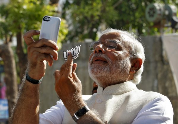 Narendra Modi takes a 'selfie' with a mobile phone, Ahmedabad, 30 April 2014 (Photo: REUTERS/Amit Dave).