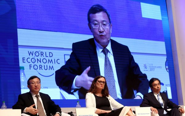 China's Vice Minister of Commerce Wang Shouwen speaks next to European Commissioner for Trade Malmstrom and Japan's Vice Minister of International Affairs METI during the Business Forum at the 11th WTO's ministerial conference in Buenos Aires, Argentina, 12 December 2017 (Photo: Reuters/Marcos Brindicci).