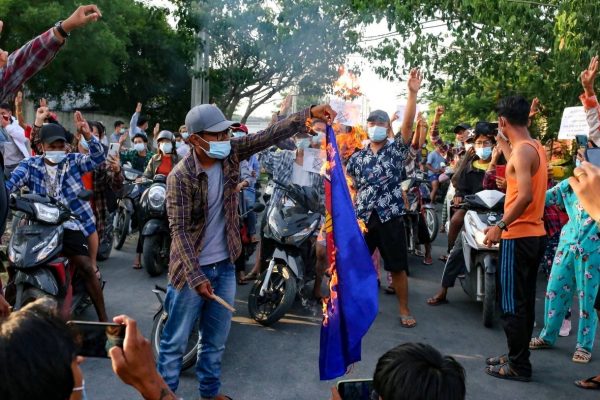 Protesters against Myanmar's junta burn the flag of the Association of Southeast Asian Nations (ASEAN), in Mandalay, Myanmar, 5 June 2021 (Photo: Reuters/Stringer).