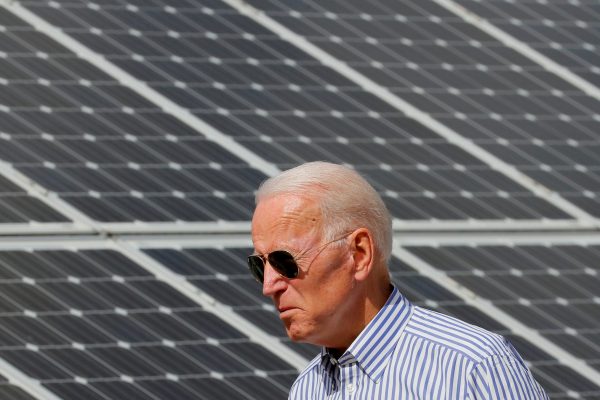 Joe Biden walks past solar panels while touring the Plymouth Area Renewable Energy Initiative in Plymouth, New Hampshire, US, 4 June 2019 (Photo: Reuters/Brian Snyder).