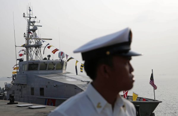 Malaysian naval officer stands in front of a Bay Class Vessel patrol boat, Port Klang, Malaysia, 27 February 2015 (Photo: REUTERS/Olivia Harris)