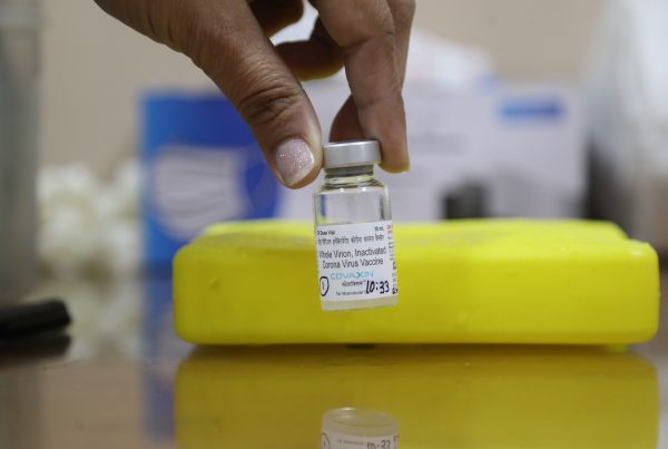 A healthcare worker holds a vial of Covid-19 vaccine COVAXIN during the second phase of the countrywide vaccination drive at Delhi Heart and Lung Institute, 2 March 2021. COVAX-IN is the India first indigenous COVID-19 vaccine developed by Bharat Biotech (Photo: Reu-ters/Naveen Sharma/SOPA Images/Sipa USA).