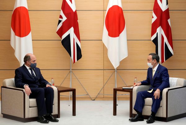 Britain's Defence Secretary Ben Wallace listens to Japan's Prime Minister Yoshihide Suga at the start of their meeting at the prime minister's official residence in Tokyo, Japan, 20 July 2021. (Franck Robichon/Pool via REUTERS)