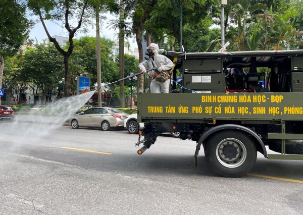 Military personnel spray disinfectant on the streets during a lockdown designed to curb the spread of COVID-19 in Hanoi, Vietnam, on 26 July 2021 (Photo: Reuters/Stringer).