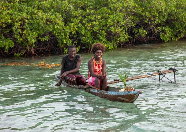 Couple on a canoe on water in Bougainville, Papua New Guinea. (Photo: Eric Lafforgue/Hans Lucas via Reuters).