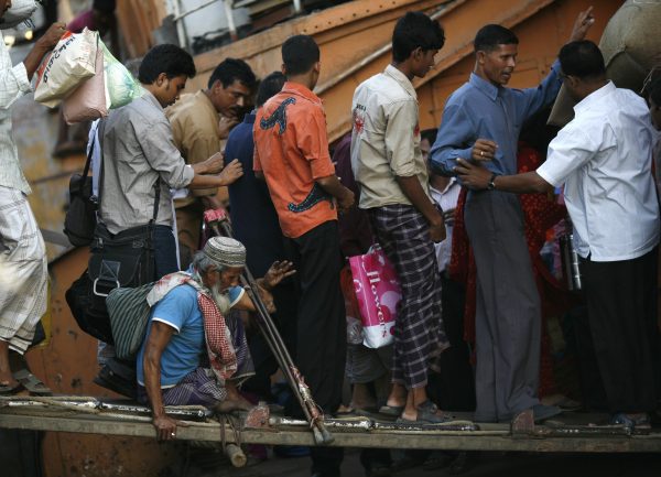 A physically handicapped passenger boards a government-run boat at Sadarghat in Dhaka 8 November 2009. (Photo: REUTERS/Andrew Biraj)