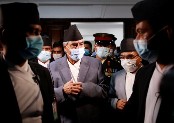 Newly appointed Prime Minister Sher Bahadur Deuba, wearing a face mask, walks after formally assuming office, Kathmandu, Nepal 13 July, 2021 (Photo: REUTERS/Navesh Chitrakar)