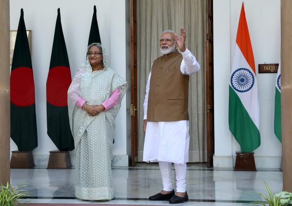 India's Prime Minister Narendra Modi waves to the media next to his Bangladeshi counterpart Sheikh Hasina before their meeting at Hyderabad House in New Delhi, India, 5 October, 2019 (Photo: Reuters/Altaf Hussain).