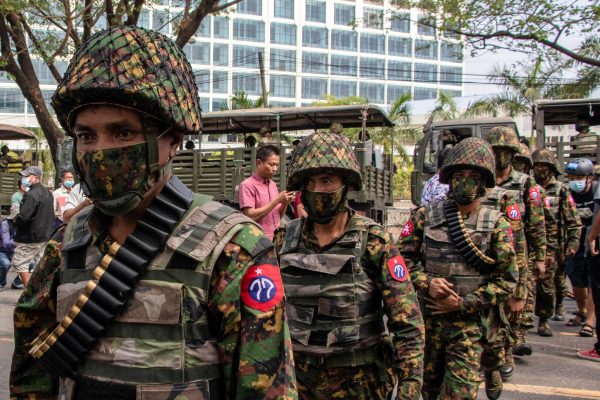 Soldiers patrolling the street in front of the Central Bank building during a demonstration, Yangon, Myanmar, 15 February 2021 (Photo: REUTERS/ Santosh Krl)