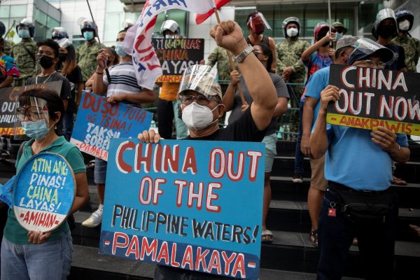 Activists stage a protest outside the Chinese Consulate, guarded by Philippine police, on the fifth anniversary of an international arbitral court ruling invalidating Beijing's historical claims over the waters of the South China Sea, in Makati City, Philippines, July 12, 2021. REUTERS/Eloisa Lopez