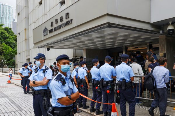Police stand guard outside the High Court during court hearing of Tong Ying-kit, the first person charged under a new national security law, in Hong Kong, China, 30 July 2021 (Photo: Reuters/Tyrone Siu).