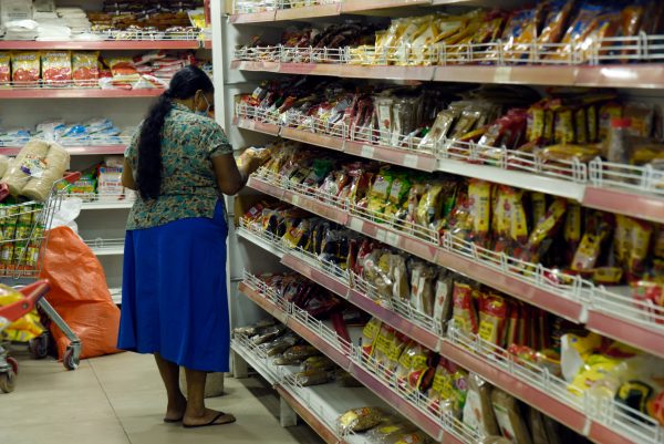 Woman buys essential food items at the supermarket after the Sri Lankan Government imposed a maximum price rate for key foods, Colombo, Sri Lanka, 3 September 2021 (PHOTO: Reuters/Akila Jayawardana/NurPhoto)