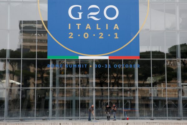 Workers clean in front of the Rome Convention Centre 'La Nuvola', in the city's EUR district, that will host the G20 summit with heads of state from major nations for a two-day meeting from October 30-31, in Rome, Italy, 22 October 2021 (Photo: Reuters/Remo Casilli).