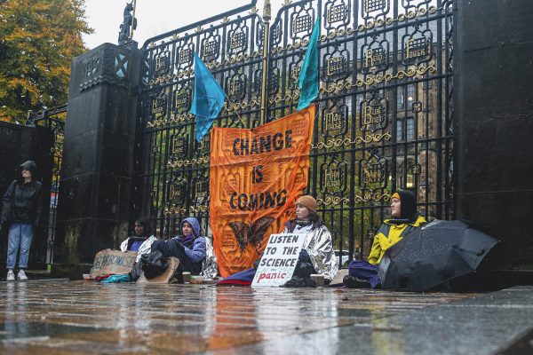 Four activists from Extinction Rebellion Glasgow University lock themselves to the Memorial Gate at the University of Glasgow on 29 October 2021 in Glasgow, Scotland. (Photo: Ewan Bootman/Reuters)