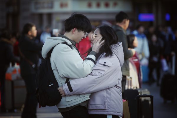 A couple of college students hugs and kisses to say goodbye as they are going back home for the upcoming Chinese Lunar New Year or Spring Festival at the Beijing railway station in Beijing, China, 25 January 2019 (Oriental Image via Reuters Connect).