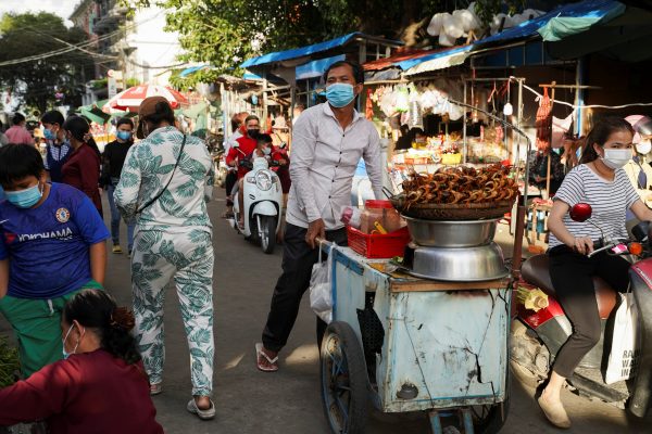 A street food vendor sells snacks at Kandal Market, during the coronavirus disease (COVID-19) outbreak in Phnom Penh, Cambodia, 12 August 2021 (REUTERS/Cindy Liu)