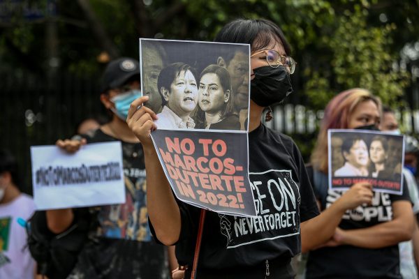 Filipino activists carry signs against government officials who filed their certificate of candidacy in the 2022 national elections during a protest in front of the Commission on Human Right, Quezon City, Philippines, 14 November 2021 (Photo: Reuters/Basilio Sepe)