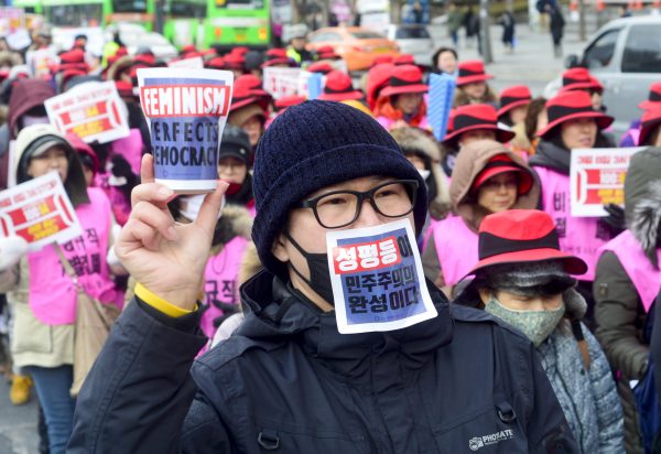 A man who attend a rally in celebration of International Women's Day is marching with banners saying ‘gender equality is the end of democracy’, Seoul, South Korea, 8 March 2017 (Photo: Reuters/Min Won-Ki).