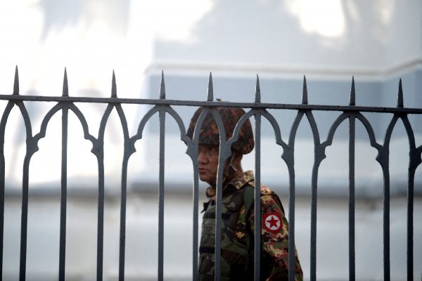 A Myanmar soldier looks on as he stands inside city hall after soldiers occupied the building, Yangon, Myanmar, 2 February 2021 (PHOTO: REUTERS/Stringer)