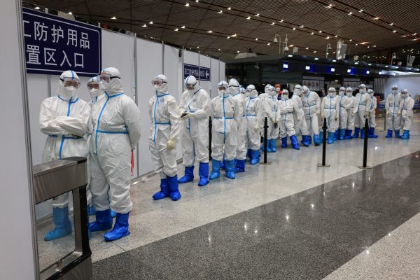 Airport employees wearing personal protective equipment (PPE) to prevent the spread of the coronavirus disease (COVID-19), are seen at Beijing Capital International Airport after the Beijing 2022 Olympic Winter Games, in Beijing, China, 21 February 2022 (Photo: Reuters/Wolfgang Rattay)