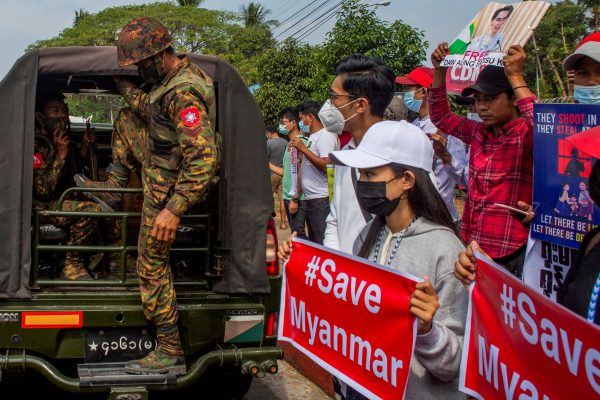 A soldier steps out of a military vehicle outside Myanmar's Central Bank during a protest against the military coup, Yangon, Myanmar, 15 February 2021 (Photo: Reuters/Stringer)
