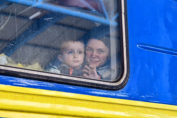A woman with a boy is seen on the evacuation train, Zaporizhzhia, southeastern Ukraine on 7 March 2022. (Photo: Reuters/Dmytro Smoliyenko)
