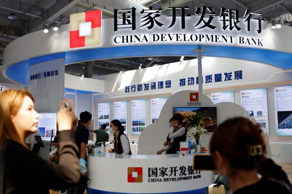 A woman takes pictures of the China Development Bank booth at the 2021 China International Fair for Trade in Services (CIFTIS), Beijing, China, 3 September, 2021 (Reuters/Florence Lo).