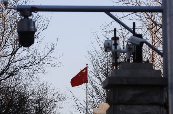 A Chinese flag is seen near surveillance cameras in Beijing, China, 31 March 2022 (Photo: Reuters/Florence Lo).