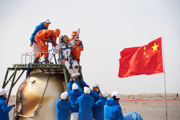 Rescue workers carry Chinese astronaut Zhai Zhigang out of a return capsule of the Shenzhou-13 manned space mission to complete construction of the space station, at the Dongfeng landing site in Inner Mongolia Autonomous Region, China, 16 April 2022 (Photo: Reuters/China Daily).