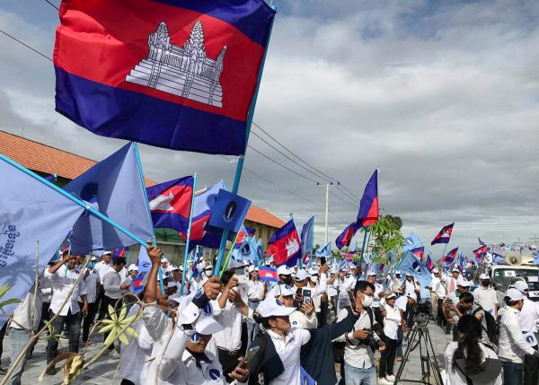 Supporters of the opposition party, Candlelight Party, wave flags as they take part in a campaign rally for the upcoming local elections on 5 June 2022 in Phnom Penh, Cambodia 21 May 2022. (Photo: Reuters/Prak Chan Thul)