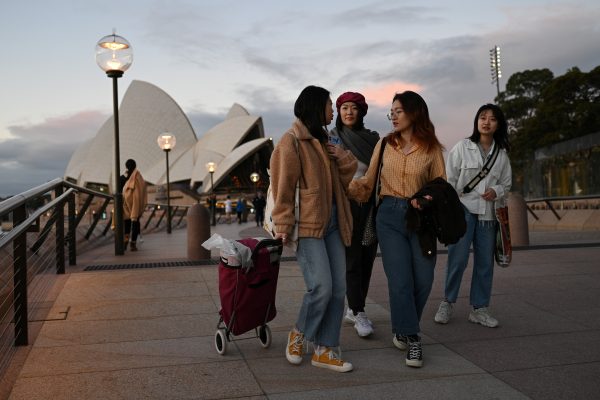 International students from China Karoline Li, Shiyu Bao, Katerina Ma and Elma Song walk along the waterfront by the Sydney Opera House, after lockdown measures put in place to prevent the spread of the COVID-19 outbreak were eased, in Sydney, Australia, 24 June 2020 (Photo: Reuters/Loren Elliott).