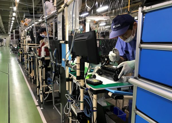 A Ricoh employee checks a drum unit on the production line at the company's printer components factory in Atsugi, Kanagawa prefecture, Japan, 13 July 2020 (Photo: Reuters/Naomi Tajitsu).