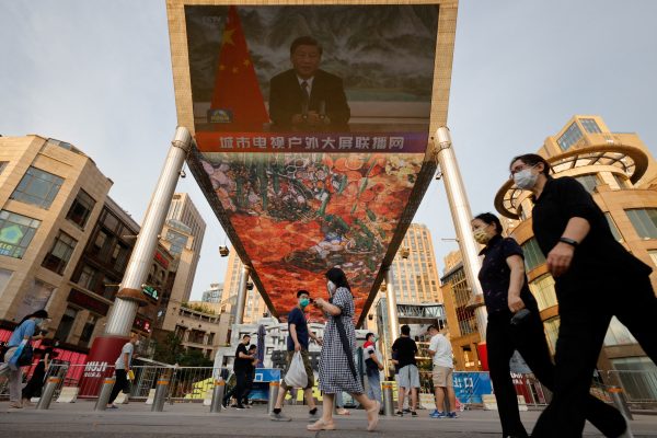 A screen shows a CCTV state media news broadcast of Chinese President Xi Jinping, addressing the BRICS Business Forum via video link, at a shopping centre in Beijing. (Photo: Reuters/Thomas Peter)