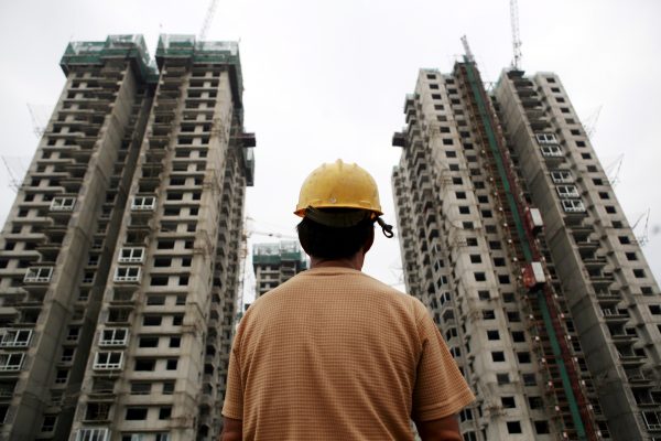 A Chinese worker labours on the construction site of a residential project in Beijing, China, 19 August 2009 (Photo: Reuters/Mu Sen)