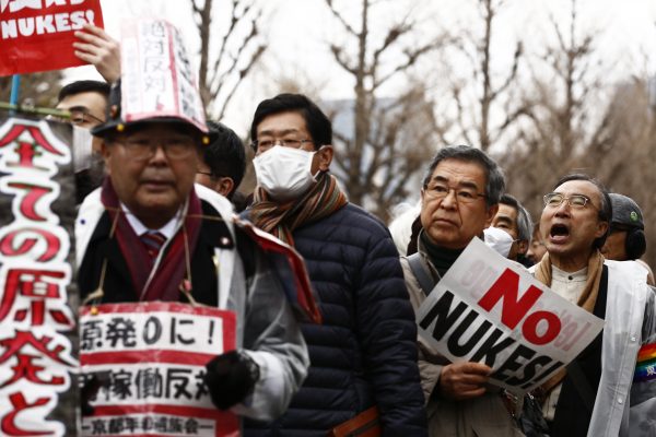 Protesters hold placards during an anti-nuclear energy rally in central Tokyo 8 March, 2015 (Photo: Reuters/Thomas Peter).